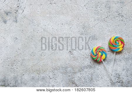 Two lollipops over a shabby chique background