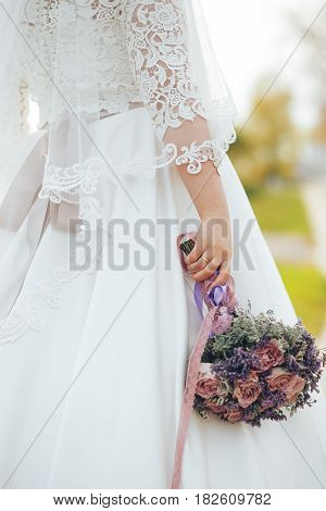 wedding bouquet in his hand of the bride