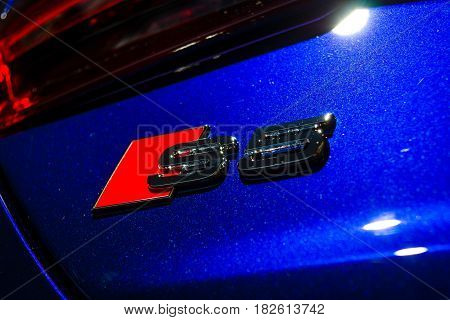 BERLIN - NOVEMBER 09 2016: Showroom. The emblem of compact executive car Audi S5 Sportback 3.0 TFSI quattro tiptronic. Close-up. Produced since 2013 (facelifted).