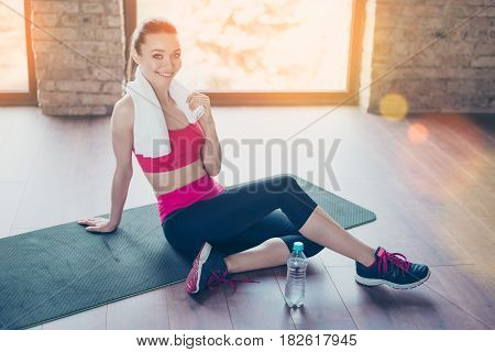 Done! Pause. Happy Young Girl Sitting On The Mat In Bright Room With Towel On Her Shoulders. She Is