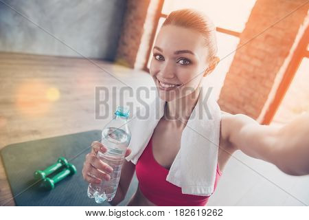 Close Up Portrait Of Beautiful Cheerful Girl In Gym. She Is Making Selfie With Camera On Her Device,