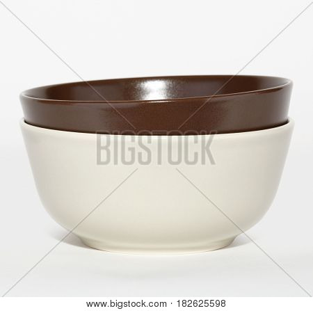 set of brown and white ceramic bowls isolated on white background