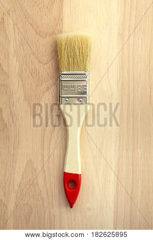 White brush on wooden background. hardwood tool