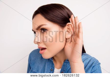 Close Up Portrait Of Brunette Girl With Cupped Hand Curiously Listening To Gossip Or Secret