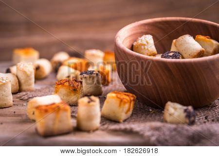 Salty party snack in wooden bowl on natural jute.
