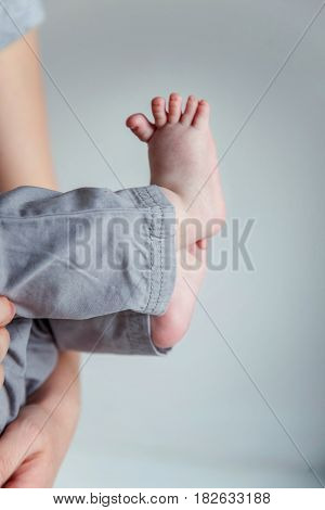 Tiny newborn infant male or female baby feet and toes