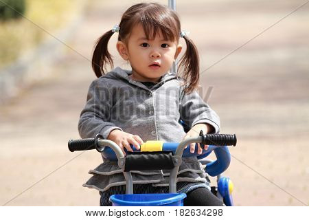 Japanese Girl Riding On The Tricycle (2 Years Old)