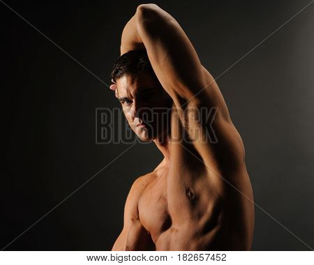 The hot guy is flexing his muscles