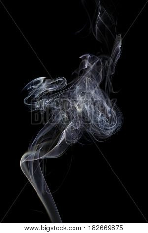 Abstract art. Color white blue smoke from the aromatic sticks on a black background. Background for Halloween. Texture fog. Design element. The concept of aromatherapy.