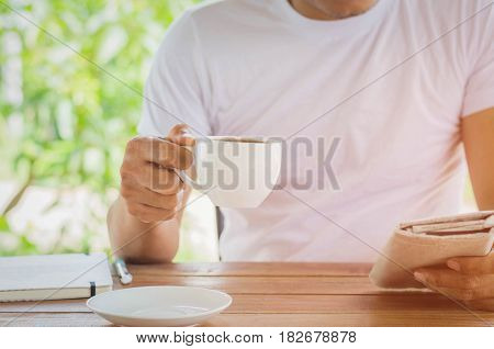 guy reading interesting news while drinking coffee at home