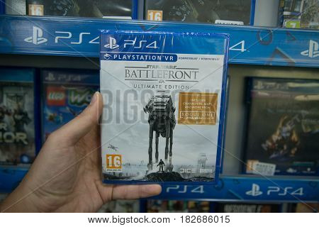 Bratislava, Slovakia, circa april 2017: Man holding Star Wars Battlefront Ultimate Edition videogame on Sony Playstation 4 console in store