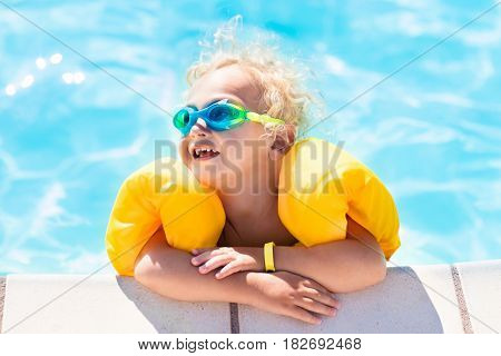 Little Baby Boy Playing In Swimming Pool