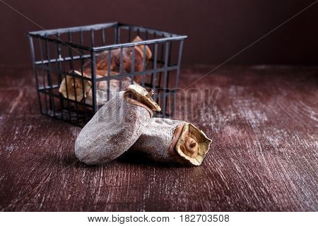 Dried persimmon fruits on dark brown background