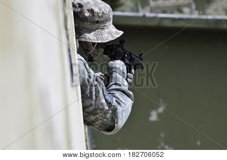 Special forces soldier aim target with sub machine gun