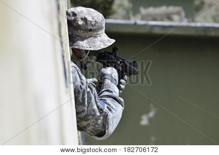Special forces soldier aim target with sub machine gun