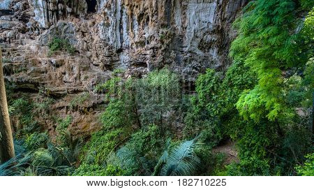 aerial photography above amazing cave. Tham Than Lod Yai is the big cave and have one hole on the top of the cave. it is a short cave there have waterfall pass inside through to another cave