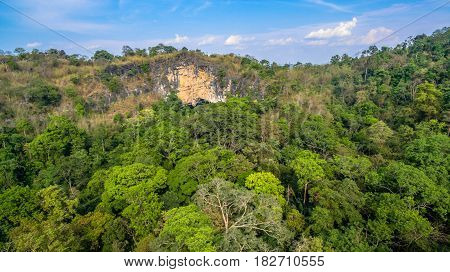 aerial photography above amazing cave. Tham Than Lod Yai is the big cave and have one hole on the top of the cave. it is a short cave there have waterfall pass inside through to another cave