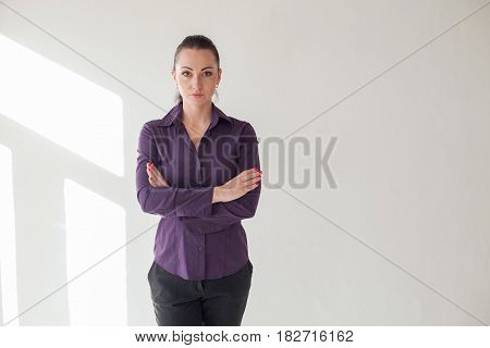 Working girl is standing in a white room