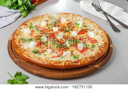 Four Cheese Pizza Quattro Fromaggi On A Rustic Wooden Board On The Table With Ingridients. Selective