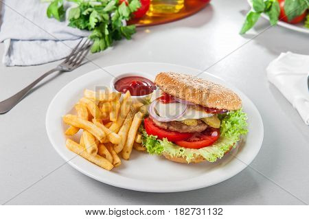 Tasty Burger Set - Meat Burger, French Fries And Sause On The White Round Plate On The Served Table