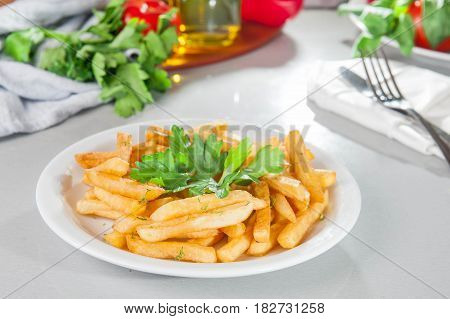 A Serving Plate Of French Fries On The Served Table With Fresh Ingridients. Close- Up. Selective Foc