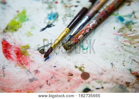 Paints and brushes. Colorful bright artistic brushes and paints. Abstract background with brushes.