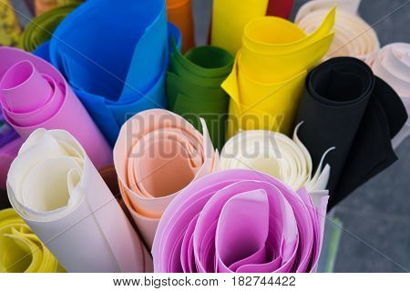 Pictire of Rolls of colored paper lying next to each other