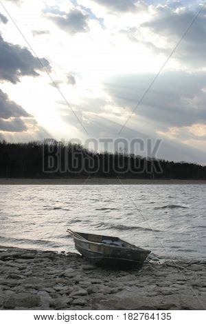Rowboat sitting by the lake on a winter evening