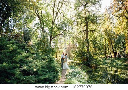 Happy Couple Walking In Summer Park