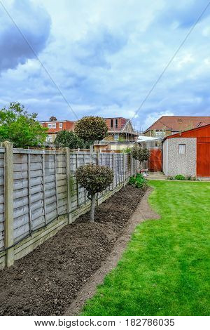 Semi-detatched garden lawn and flower bed ready for new planting springtime shot.
