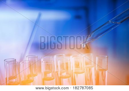 Lab experiment. Laboratory concept background.
Tubes during experiment in laboratory. Colorful bokeh.
