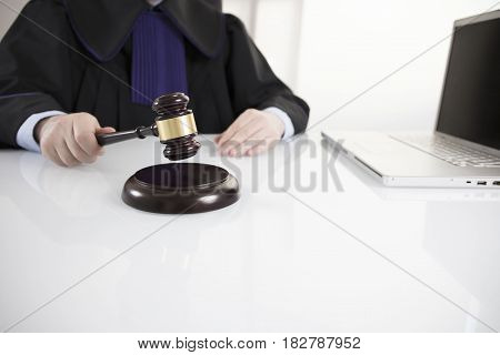Mallet in the hand of the judge. Law concept.
