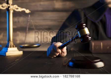 Mallet in the hand of the judge. Law concept.