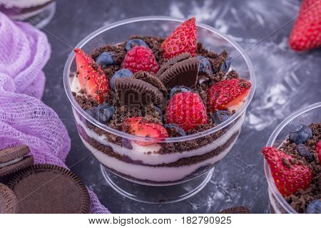 A dessert with berries on a basis cream mascarpone cheese with fresh berries and cookies