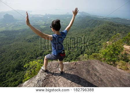 success young woman rock climber on mountain peak