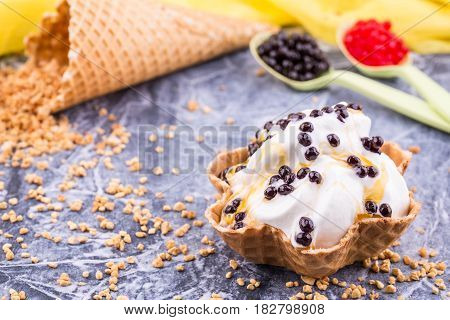 An ice cream basket with lemon jam, sprinkled chocolate balls