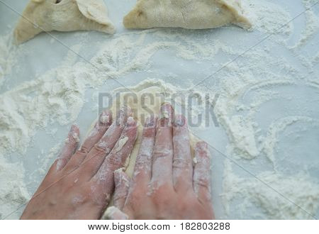Preparing dough. Baking peremech concept. Flour, dough and meat cooking ingredients. Hands top view of cooking belyash cuisines