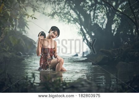 Asian sexy woman bathing in creek Thailand