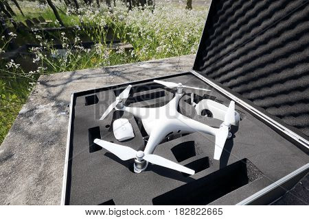 KAGAWA, JAPAN - APRIL 22, 2017: White drone Dji Phantom4 Pro stay in metal bag and ready to fly.