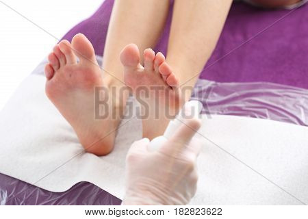 Foot hygiene
Podology, preparation of feet for surgery
Skin disinfection, beautician disinfects the feet of women with the preparation