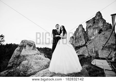 Lovely Wedding Couple Against Rocks Of Fortess Tustan At Carpathian Mountains.