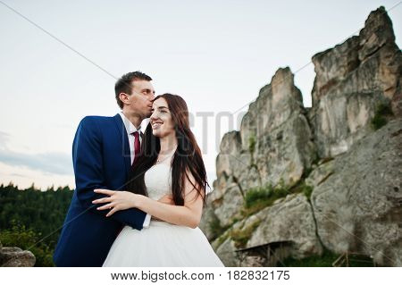 Lovely Wedding Couple Against Rocks Of Fortess Tustan At Carpathian Mountains.