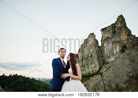 Lovely Wedding Couple Against Rocks Of Fortess Tustan At Carpathian Mountains.
