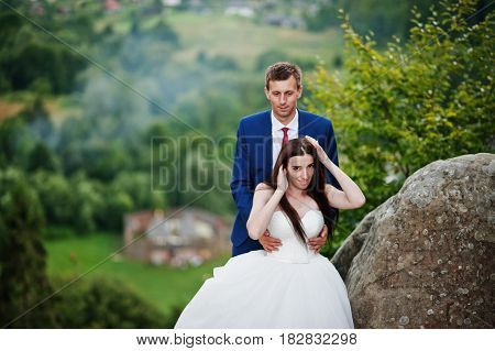 Lovely Wedding Couple Against Rocks Of Fortess Tustan At Carpathian Mountains.