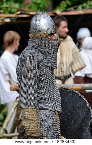 TERVETE LATVIA - AUGUST 13 2011: Historical Zemgalu days. Unknown man dressed in ancient armor with weapons and shield.
