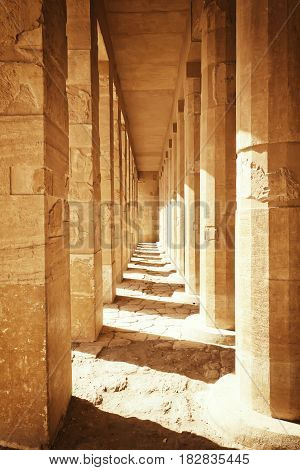 Colonnade of ancient columns at the Temple of Queen Hatshepsut at Luxor (Egypt ). Edited as a vintage photo with dark edges.