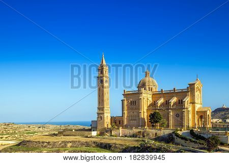 Gozo Malta - The Basilica of the National Shrine of the Ta' Pinu early at the morning with clear blue sky on a summer day