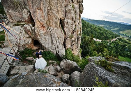 Lovely Wedding Couple Against Rocks Of Fortess Tustan At Carpathian Mountains.