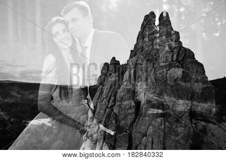 Double Exposition Of Lovely Wedding Couple Against Rocks Of Fortess Tustan At Carpathian Mountains.