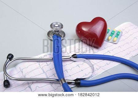RX prescription, Red heart, asorted pils and a stethoscope on white background.